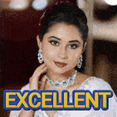 a woman wearing a necklace and earrings stands in front of a poster that says excellent