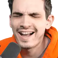 a man wearing an orange hoodie is making a funny face