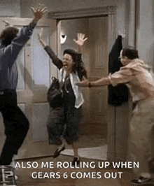 a man and a woman are jumping in the air while a man holds a woman 's hand .