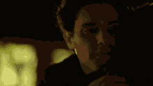 a close up of a man 's face with a dark background