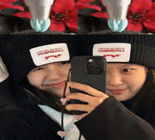 two girls wearing beanies with yobbevoj written on them