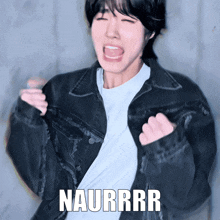 a person wearing a black jacket and a white shirt with naurrr written on the bottom