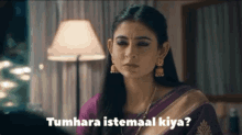 a woman in a purple and gold saree says tumhara istemal kiya