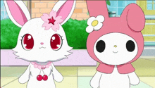 a white rabbit and a pink bunny are standing next to each other .