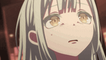a close up of a girl 's face with a tear on her cheek