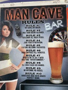 a sign for the man cave bar with rules