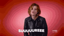 a woman in a leather jacket is making a funny face and saying suuuuree .