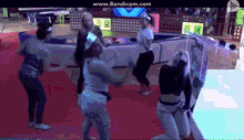 a group of people are dancing in a room and the website www.bandicam.com is visible