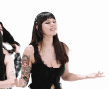 a woman in a black top has a tattoo on her arm that says " i love you "