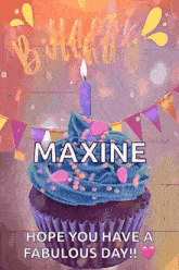 a birthday cupcake with blue frosting and a candle with the name maxine on it