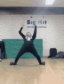 a person is doing a trick in front of a sign that says big hit entertainment