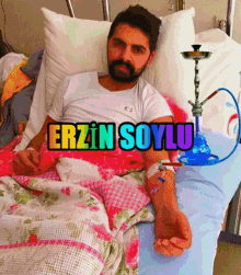 a man is laying in a hospital bed with a hookah and the words erzin soylu written above him