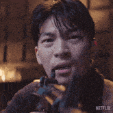a man holding a gun with the word why written on his face