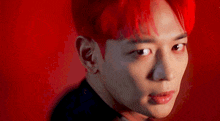 a close up of a person with red hair looking at the camera .