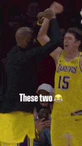 a basketball player in a lakers jersey is being high fived by another player