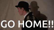 a man wearing a hat and a jacket says go home