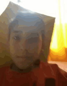 a close up of a child 's face with a piece of paper covering his head