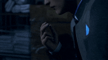 a man in a suit and tie is holding his hand to his mouth