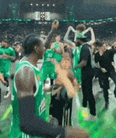 a group of basketball players in green uniforms with the number 22 on them