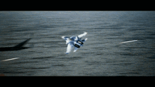a fighter jet is flying over the ocean with missiles coming out of it