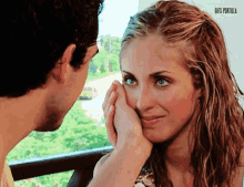 a man is touching a woman 's face with his hand and the words gif 's tortilla are above them