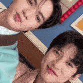 a couple of young men are posing for a picture together .