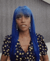 a woman with blue hair and earrings is wearing a leopard print dress .