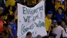 a group of people holding up a banner that says england see we coke