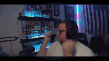 a man wearing headphones is sitting in front of a microphone with the letters wn on his chair