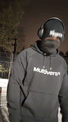 a man wearing headphones and a hoodie that says " multivers "