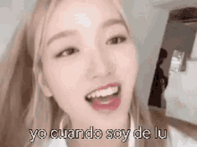 a close up of a woman 's face with the words `` yo cuando soy de lu '' written below her .