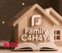 a wooden house sitting on top of an open book .