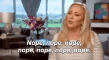 a woman is sitting in a living room with her eyes closed and saying nope , nope , nope , nope .