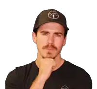 a man wearing a black hat and a black shirt is giving a thumbs up sign
