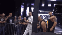 a man stands in front of a sign that says design on it