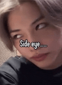 a close up of a person 's face with a caption that says `` side eye '' .