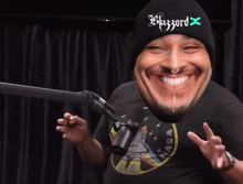 a man wearing headphones is laughing in front of a microphone with the words `` hahaha '' written on it .
