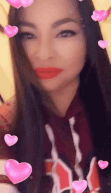 a woman with long hair and red lips is surrounded by pink hearts