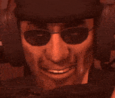 a close up of a man wearing sunglasses and a helmet