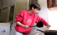 a man wearing a red sweatshirt that says scotty 's place