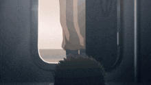 a person is standing in a doorway with their feet up