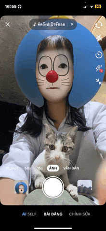 a woman wearing a clown mask is taking a selfie with her cat