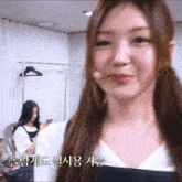 a girl with a microphone in her mouth looks at the camera while another girl looks at her phone