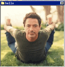 a picture of a man laying on the grass with a folder labeled hello in the corner