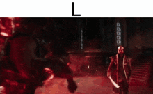 a man with a sword is fighting another man in a dark room with red lights .