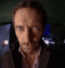 a close up of a man 's face looking at the camera .