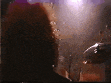 a purple light is shining on a person 's head