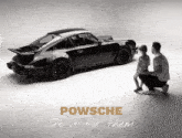 a black and white photo of a man and child looking at a porsche with the caption powsche do it for them