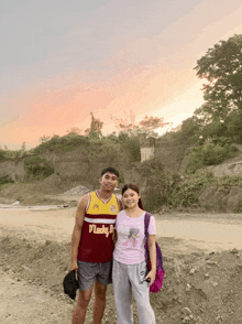 a man wearing a lucky jersey poses with a girl
