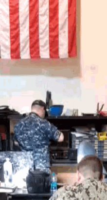 a man in a military uniform is working in a kitchen
